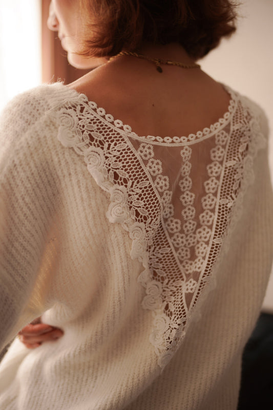 Soft ecru knit sweater featuring an intricate floral lace back panel with a delicate bohemian vibe